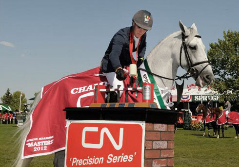 Mounted on horseback, Olivier Philippaerts collects his trophy.