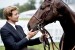 Simon Baker poses with a Thoroughbred race horse.
