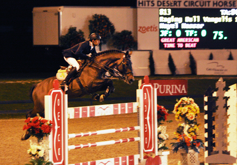 Nayel Nassar and Raging Bull Vangelis S clear a jump on a night course.