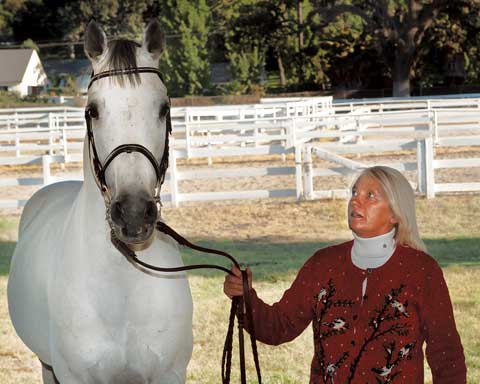 Anke Magnussen poses with her grey stallion Contefino