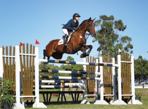 Ashlee Bond and Wistful clear a huge Swedish oxer in a grand prix course on the grass.