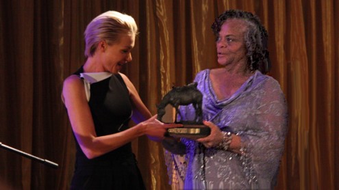 Portia de Rossi accepts her bronze trophy from Mayisha Akbar.