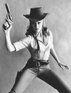 Jane Fonda poses in cowboy hat with six-shooter gun