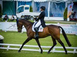 Hannah Sue Burnett and her bay horse Harbor Pilotcompete in the dressage phase of three-day eventing.