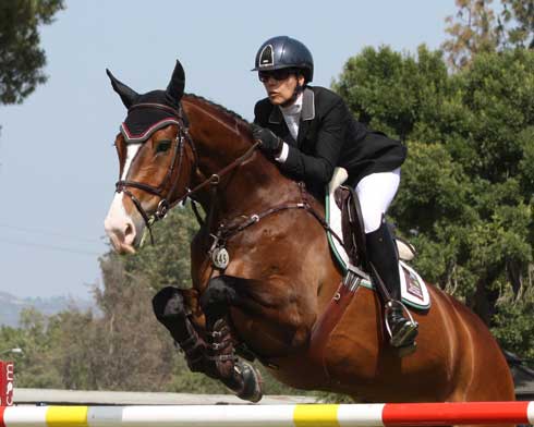 Susan Artes exhibits perfect rider form as she clears a jump on Zamiro.