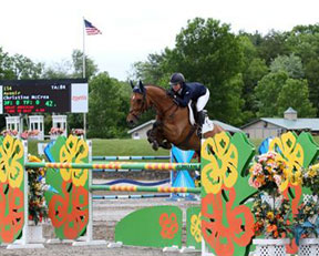 Christine McCrea and Avenir clear a very colorful jump.