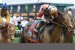 Jockey Joel Rosario raises his crop in victory as a mud-splattered Orb crosses the finish line at the Kentucky Derby.