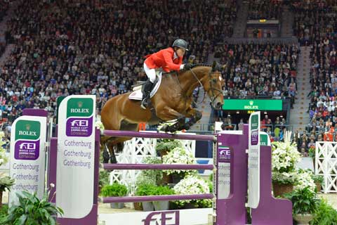 Beezie Madden and Simon jump before a crowd packed to the rafters.