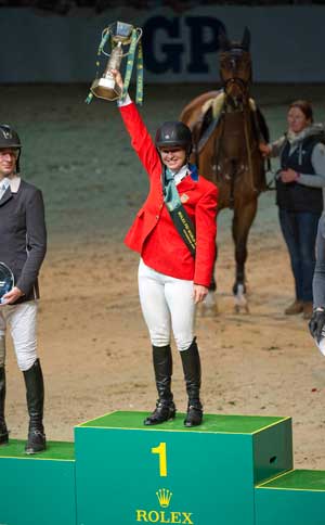 In the bright red jacket of the USA, Madden cuts a stylish figure as she hoists her trophy..