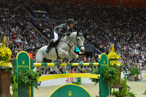 Kevin Staut and his grey mare clear a huge vertical.