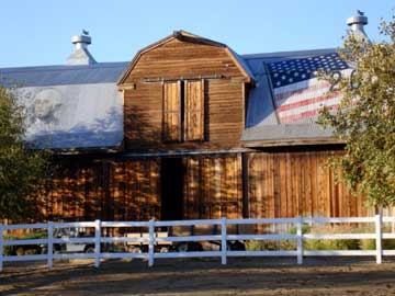 Classic American barn, with image of George Washington and U.S. flag on the roof.