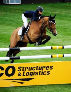 Reed Kessler and Ligist clear a tall yellow and white plank jump.