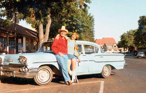 Marc and Royan Herman post near a powder-blue 1950s Chevy.