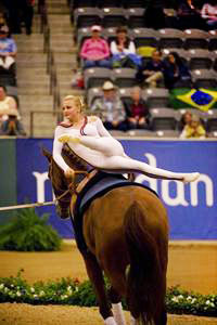 Mary Garret vaulting on her horse.