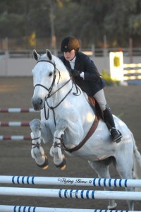 Kali Jelen rides huntseat on her grey horse Cavallo.