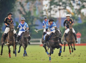 Polo player Ameer Jumabhoy charges forward on his horse in an action-packed chukker.