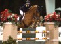 Kristen Coe and her chestnut horse clear a huge jump.