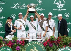 Dressed in whites, the Grants Farm team hoists its trophy for the Lucchese Cup.