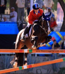 Beezie Madden and the mare Coral Reef Via Volo soar over a large vertical.