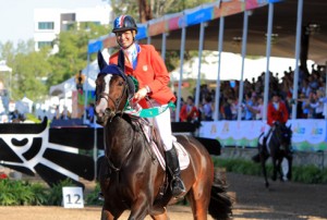 Beezie Madden beams and gives her horse a pat after her third immaculate round at the 2011 Pan American Games.