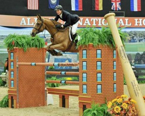 McLain Ward and his horse Rothchild jump a mock brick building at the Alltech National Horse Show.