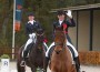 Australian riders Lyndal Oatley on Potifar and Mary Hanna on Sancette wave with pride as they take their "honor lap" at the Olympic qualifier.