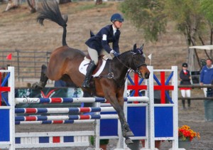 Jolie Wentworth and her bay horse Good Knight sail over a red, white and blue Swedish oxer at Galway Downs.