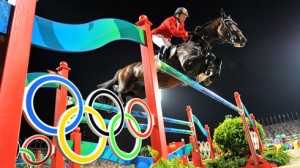 Eric Lamaze and Hickstead sail over a brightly colored jump, decorated with the Olympic rings, at the 2008 games.