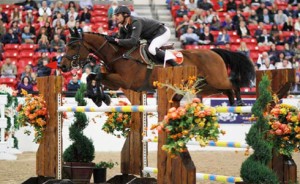 Eduardo Menezes sails over a vertical jump on his horse Calavda before a full house in Las Vegas.