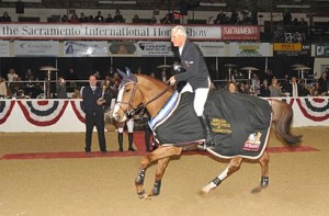 Rich Fellers takes his chestnut stallion Flexible on a victory gallop after winning the Grand Prix at the 2011 Sacramento International Horse Show.