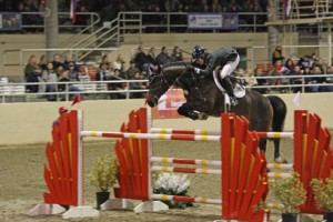 Shelley Fellers and her bay horse Revenge tackle a huge oxer.