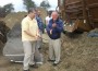 George Chatigny and Rudy Leone stand before a huge pile of arena footing.