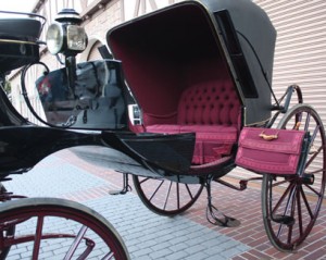 Laquered black with crimson accents, the two-seat and "barouche" is very elegant.