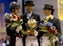 Dujardin, Peters and Vilhelmson-Silfvén hold flowers and trophies on the podium at the World Dressage Masters.