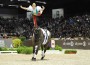 Woman standing on one foot on her cantering horse