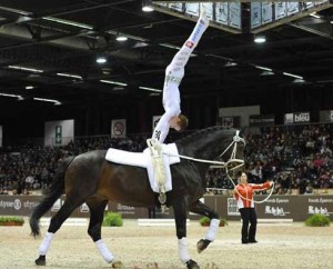 Man doing a handstand on his horse