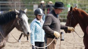 Buck Brannaman instructs a young student and her horse at his clinic.