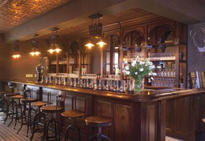 Wood-paneled interior of the tavern at the Diamond Mills Hotel.