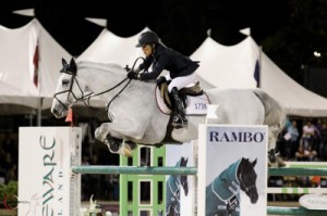 White horse and rider Margie Engle clear a huge jump.