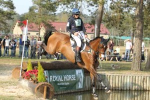 Clayton Fredericks and his bright bay horse Bendigo land in a water bank.