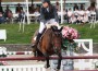 Saer Coulter and her bay horse clear a red vetical jump.