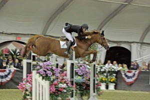 Karl Cook and the chestnut stallion Uno de Laubry soar over an oxer.