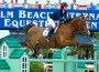 Reed Kessler and Cylana jump a bright green oxer built on a "house" motif.