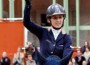 Ukrainian rider Katharina Offel hoists her trophy above her head.