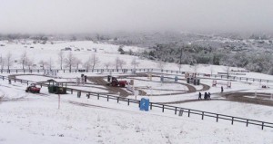 Wide show of the main ring at 3 Day Ranch covered in snow.