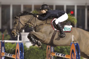 Lucy Davis and her bay horse Nemo 119 soar over a jump.