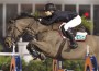 Lucy Davis and her bay horse Nemo 119 soar over a jump.