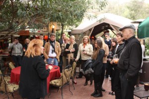 Wildlife Waystation founder Martine Colette addresses a crowd of people on her outdoor patio.