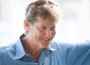 Portrait of Robert Ridland in sunshine wearing a sky blue shirt.