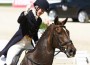 Allison Springer gives a victory pump with her fist after a successful dressage ride.